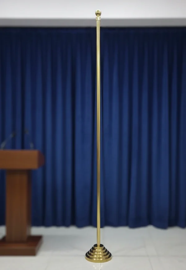 A Indoor Pole of Brass Standing On a Stage