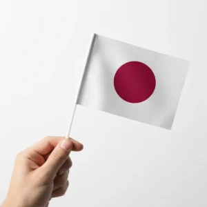 A Small Hand Flag of Japan Hold by a hand