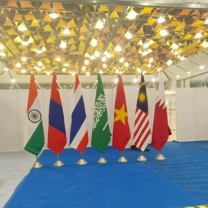Some Country Flags stands In a hall With Indoor Poles
