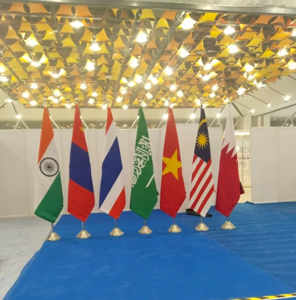 Some Country Flags stands In a hall With Indoor Poles