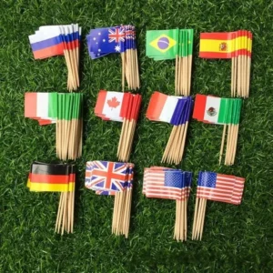 Miniature paper flags of various countries on wooden sticks