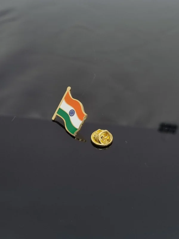 A small India flag lapel pin with its golden clasp