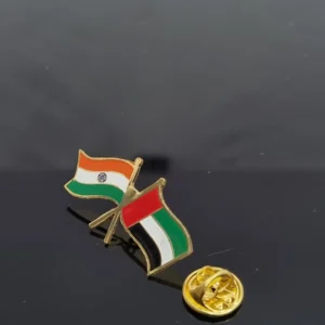 Metal lapel pin with polished finish on a plain background.