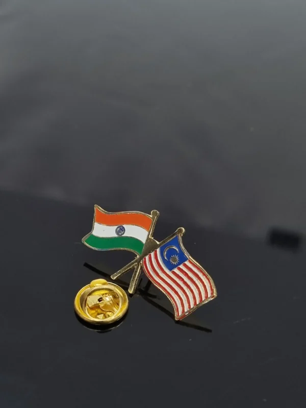 Crossed India and Malaysia flag lapel pin with a gold clasp.